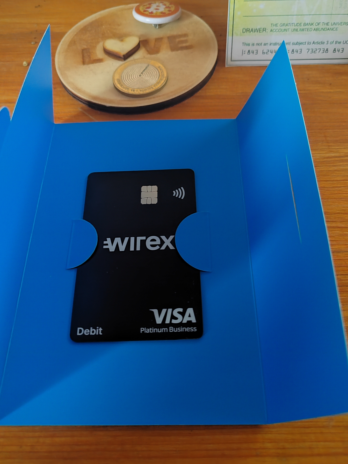 Wirex Visa Platinum Business card for Wise World 2012 Ltd next to LOVE Coin token