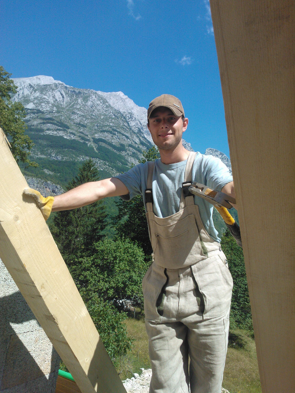 Miha working on a roof, wearing hemp clothes
