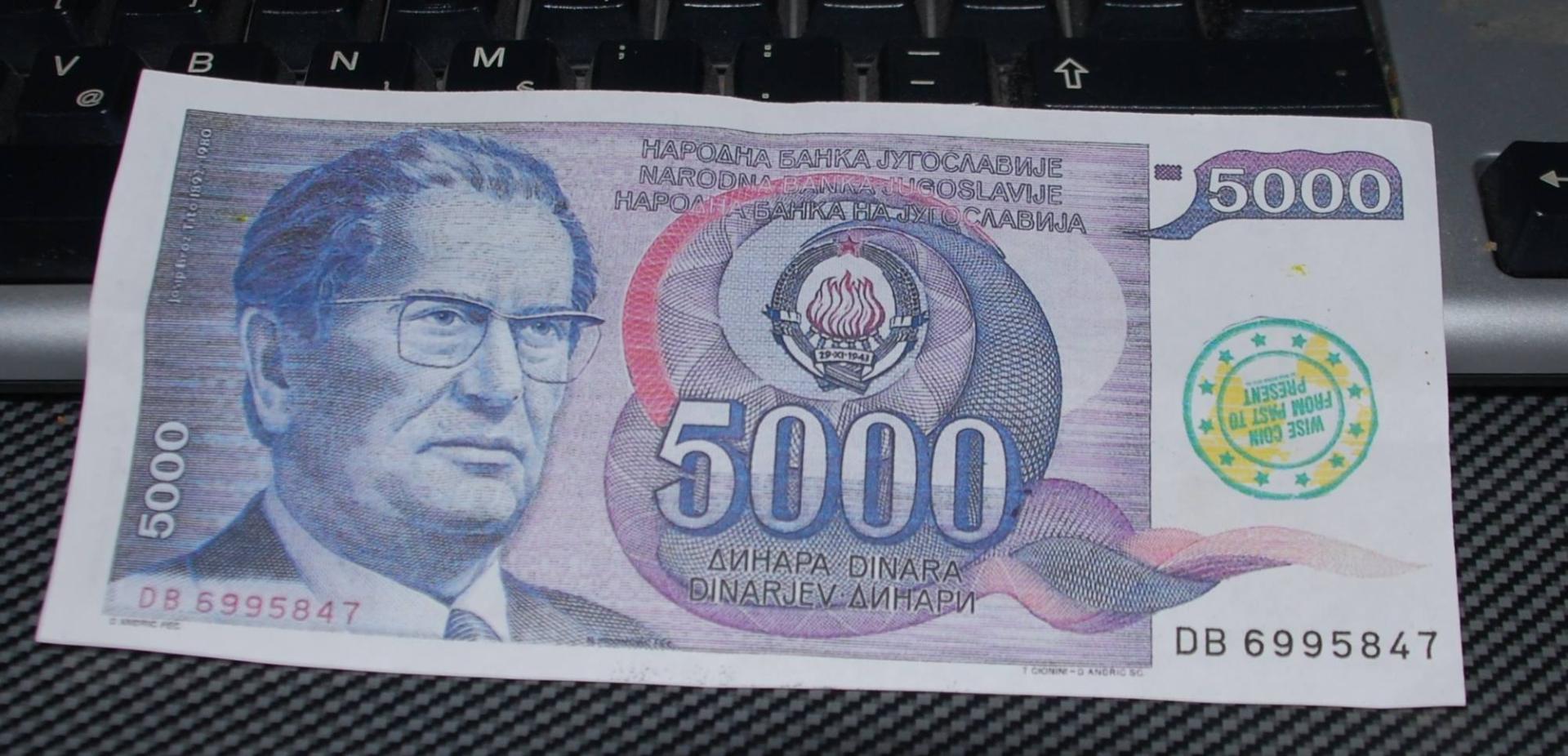 Yugoslav 5000 dinar banknote with portrait of Marshal Josip Broz Tito, stamped with a Wise World 2012 mark — currency of a country that no longer exists.