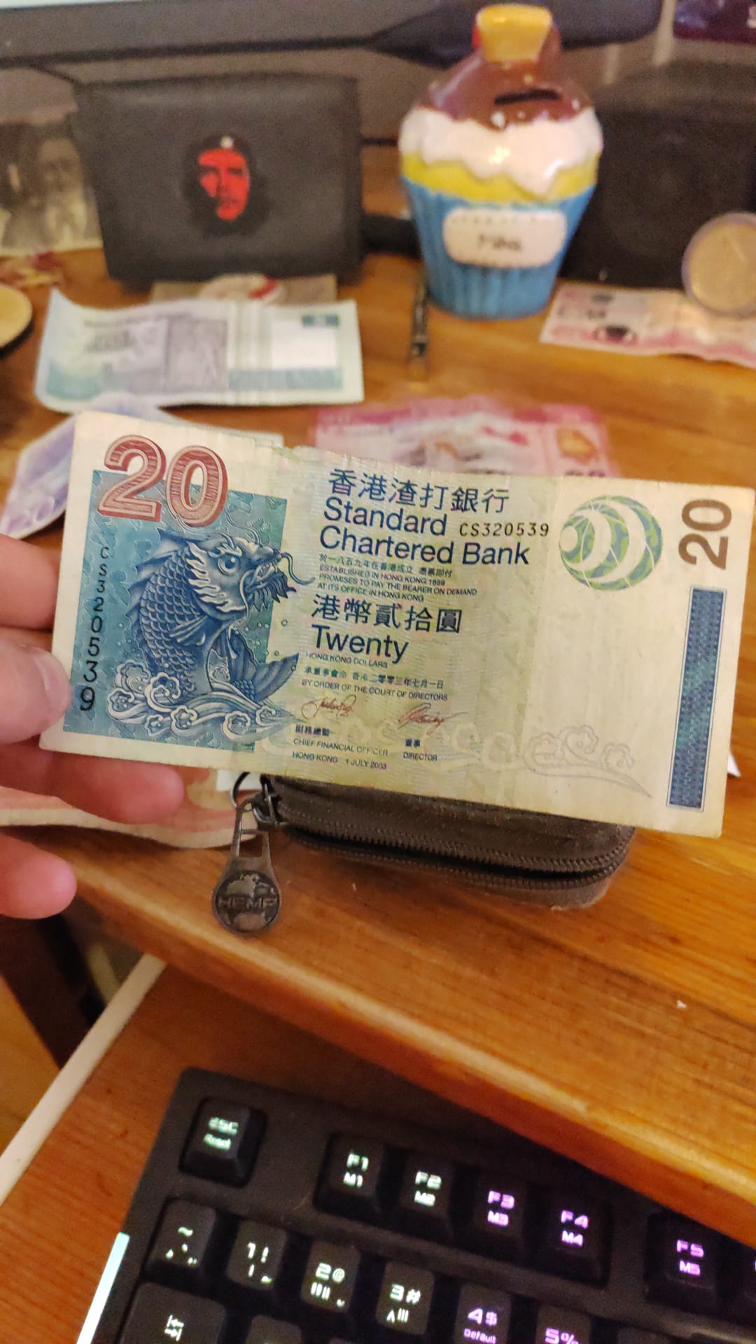 A Hong Kong 20 dollar banknote issued by Standard Chartered Bank in 2003 featuring a koi carp design and Chinese characters — privately issued legal tender.
